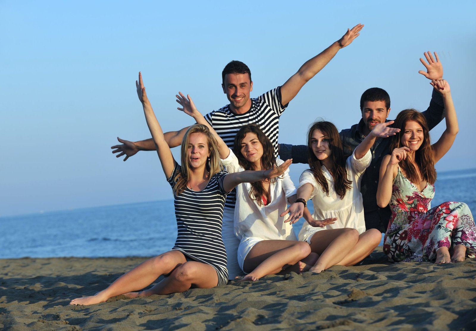 happy young  people group have fun on beach