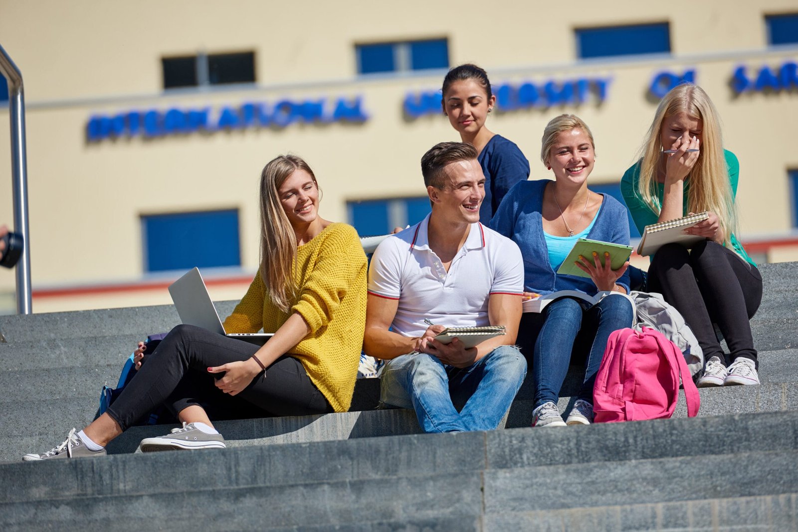 students outside sitting on steps